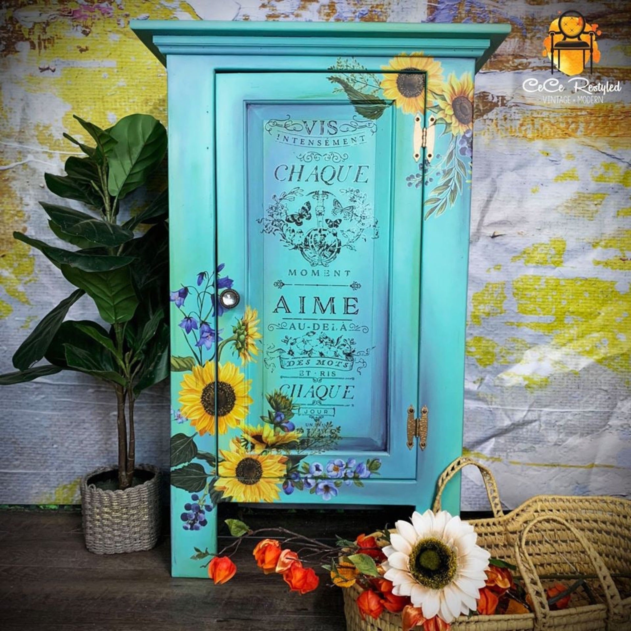 A vintage storage nightstand refurbished by CeCe ReStyled is painted light teal with a slight blend of blue and features ReDesign with Prima's Sunflower Fields transfer on the front.