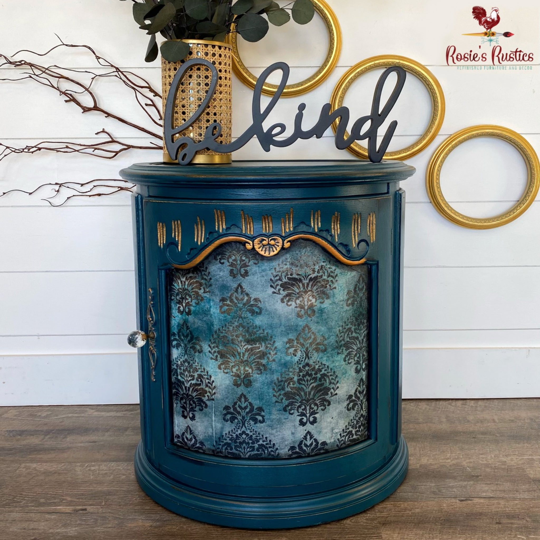 A drum style end table refurbished by Rosie's Rustics is painted blue and features ReDesign with Prima's Patina Flourish tissue paper on its door inlay.