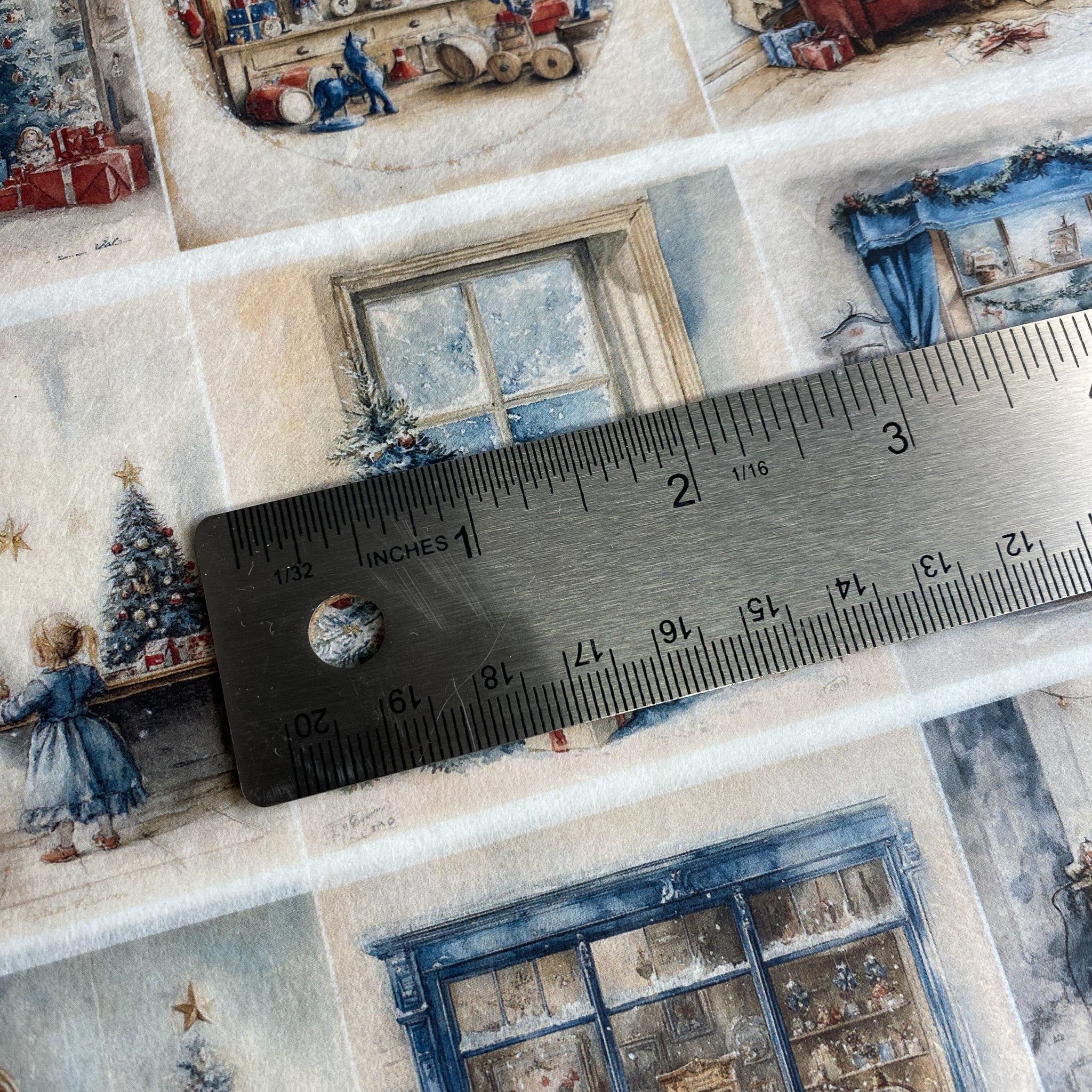 Close-up of a fabric with Christmas-themed patterns and a ruler for scale.
