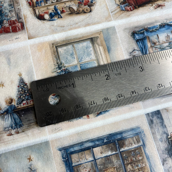 Close-up of decorative paper with Christmas-themed designs and a ruler for scale.