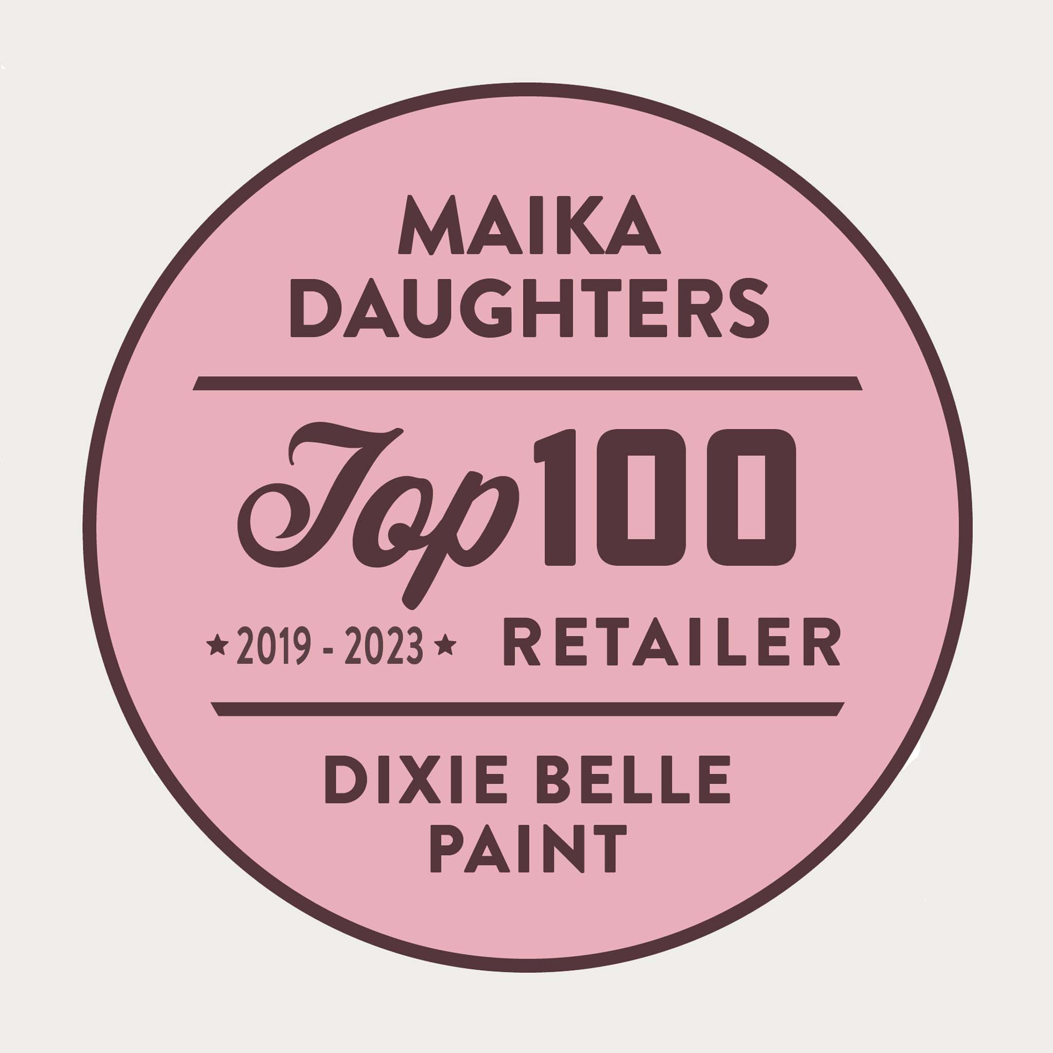 A white background with a pink circle with a brown outline and brown text reading: Maika Daughters. Top 100 2019 - 2023 Retailer Dixie Belle paint.