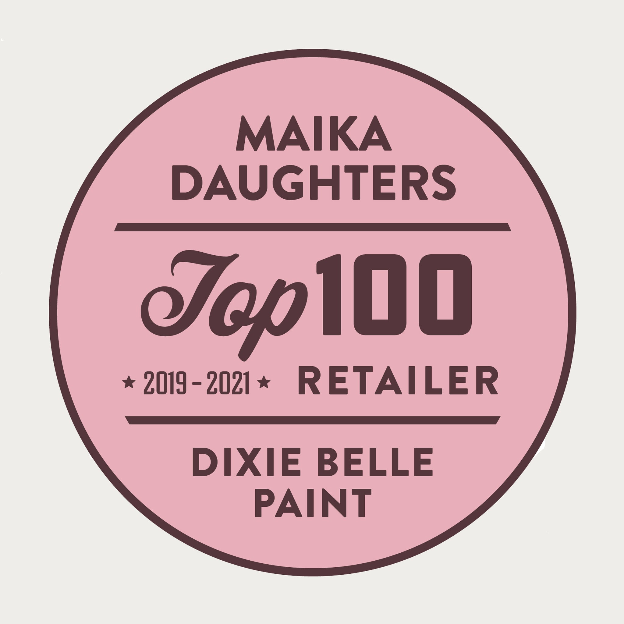 A white background with a pink circle with a brown outline and brown text reading: Maika Daughters. Top 100 2019 - 2021 Retailer Dixie Belle paint.