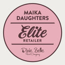 A white background with a pink circle with a brown outline and brown text reading: Maika Daughters. Elite Retailer. Dixie Belle Paint Company.