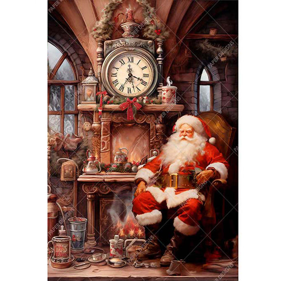 Rice paper design that features Santa hunkering down in a cozy chair in front of a crackling fireplace. White borders are on the sides.