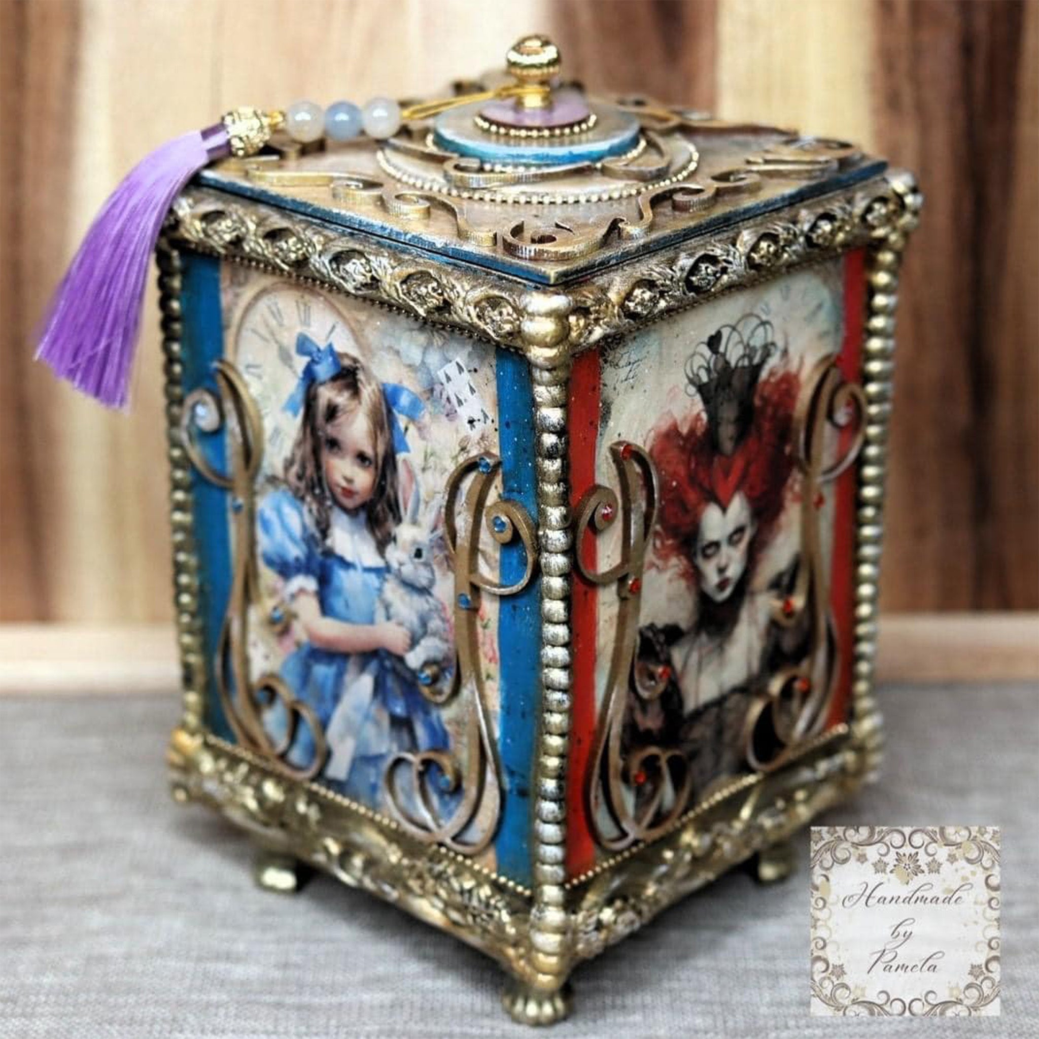 An ornate small cube jewelry box features Paper Designs Italy's Alice in Wonderland and Queen of Hearts rice paper on two sides.