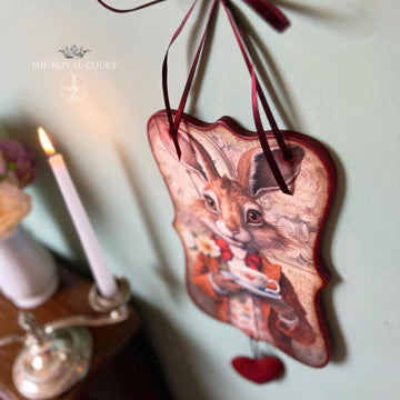 A wood hanging craft created by The Royal Court features Paper Designs Italy's The Rabbit rice paper on it. A small red heart hangs off the bottom of the craft.