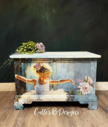 Decorative chest with a painted design of a young girl and flowers on a dark background.