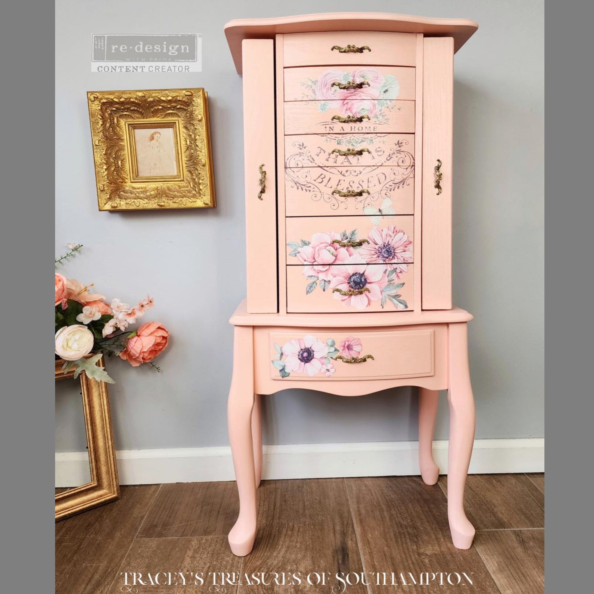 A vintage jewelry armoire refurbished by Tracey's Treasures of Southampton is painted pale coral pink and features ReDesign with Prima's Overflowing Love transfer on its front drawers.