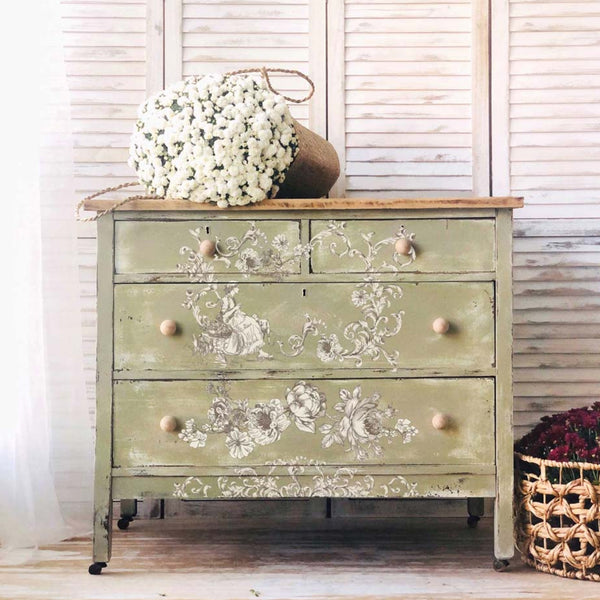 A vintage 4-drawer dresser is painted light yellow-green and features ReDesign with Prima's Alaina Toile transfer on it.