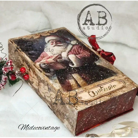 Decorative box with Santa Claus design and red ribbon, featuring 'AB Studio' and 'Midecovintage' branding.