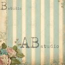 Close-up of a rice paper featuring pale blue and cream stripes with small bouquets of soft pink flowers in the top right and bottom left corners.