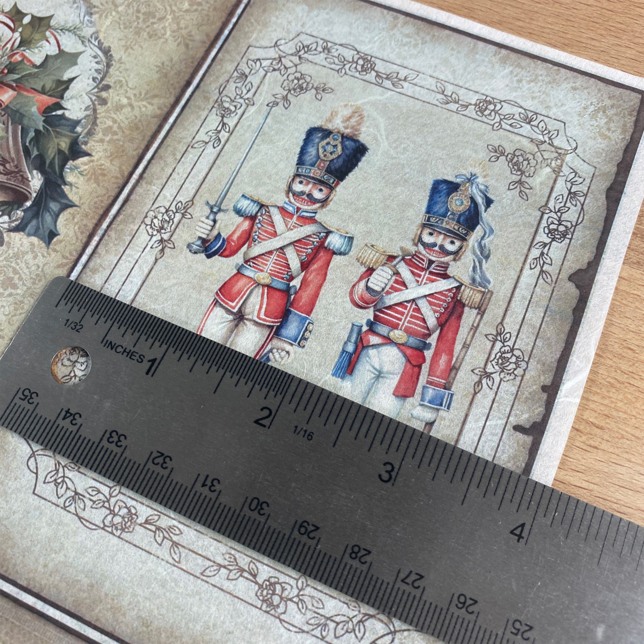 Decorative paper with two nutcrackers and a ruler for scale on a textured surface.