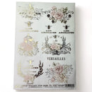 An A4 rice decoupage paper featuring floral designs, birdcages, and French writing highlighted with foil gilding is against a white background.