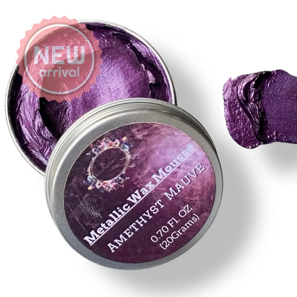 A 0.70 (20 ml) open container of a purple color metallic wax mousse paste is against a white background.