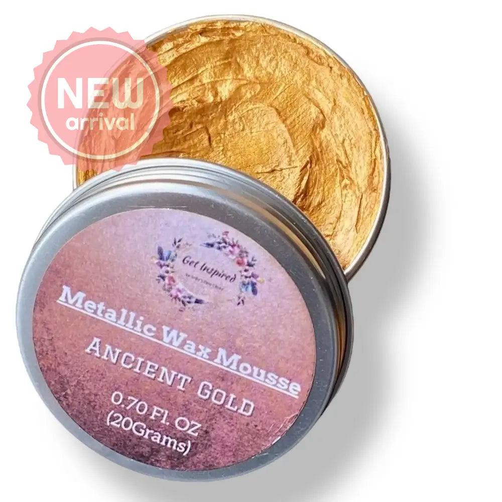 A 0.70 (20 ml) open container of a rich gold color metallic wax mousse paste is against a white background.