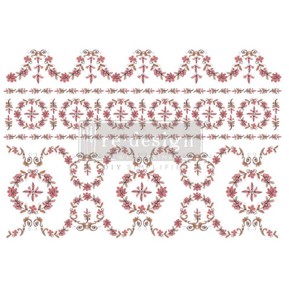 Rub-on transfer that features a dainty, winding floral pattern in stunning shades of blush and brown.