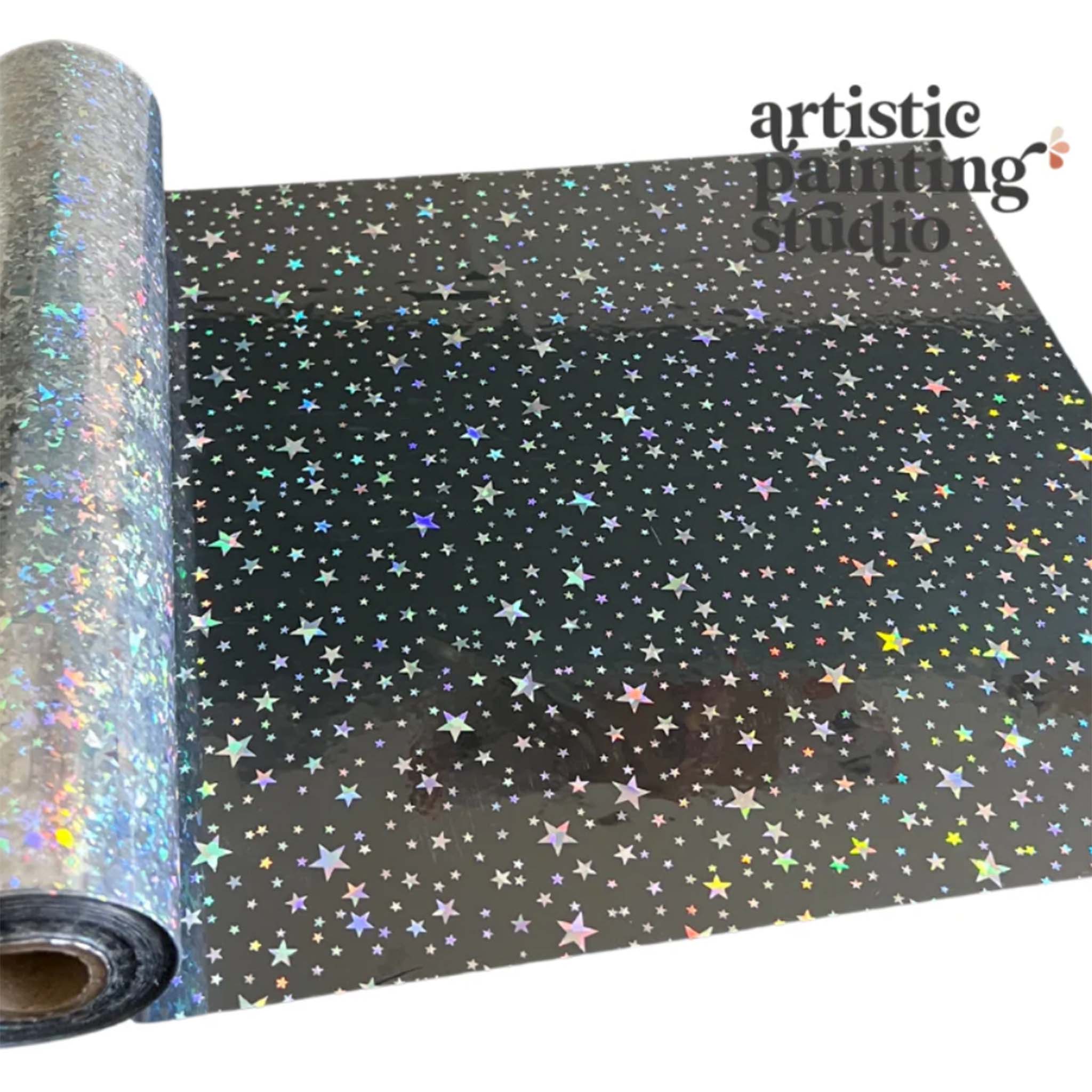 A roll of a silver holographic foil transfer that features an array of stars is against a white background.