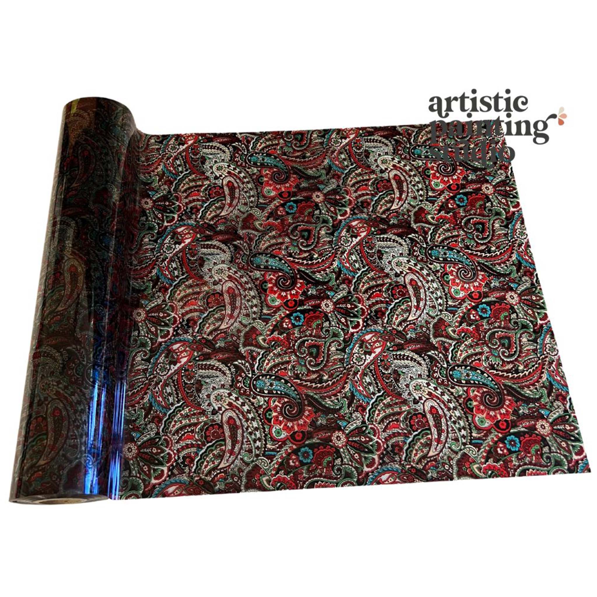 A roll of a transparent metallic transfer foil that features red and light blue paisley is against a white background.