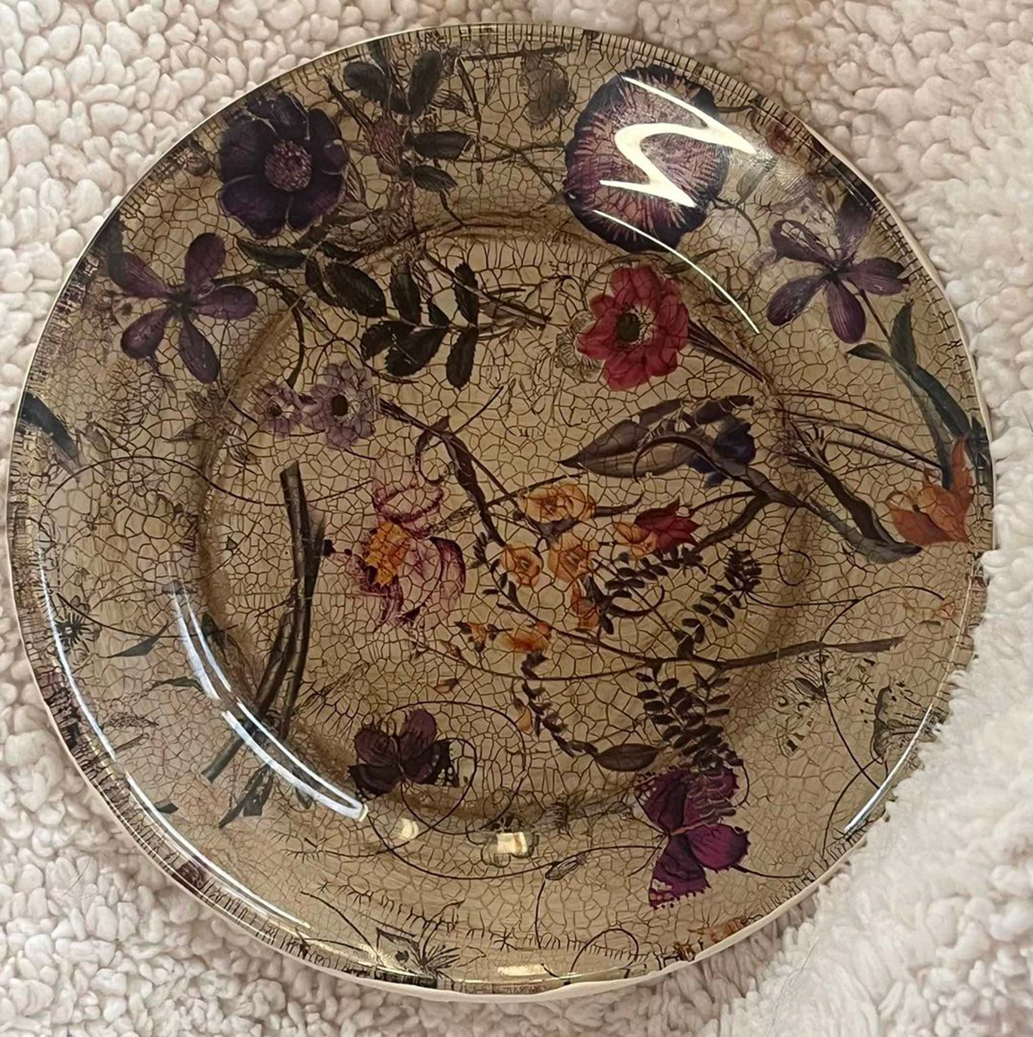 A ceramic plate with a crackle finish features Artistic Painting Studio's Serenity Floral transparent metallic transfer foil on it.