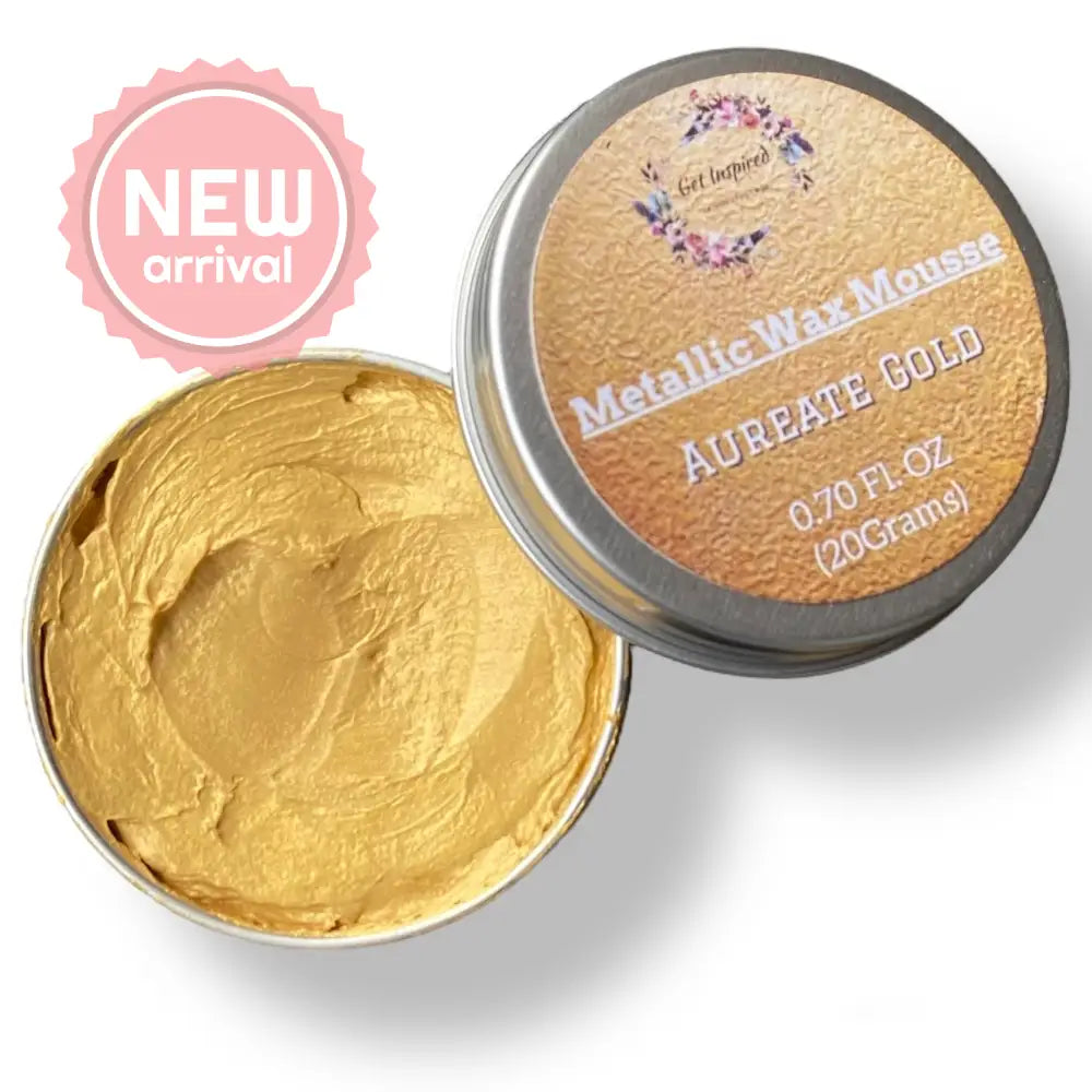 A 0.70 (20 ml) open container of a gold color metallic wax mousse paste is against a white background.