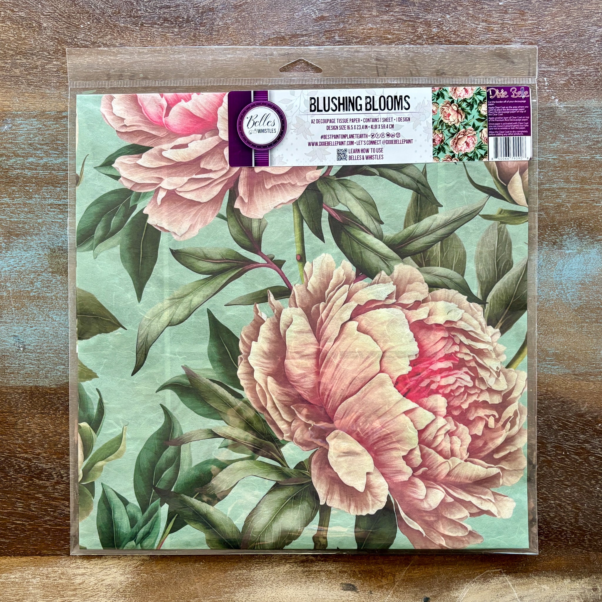 A package of Belles and Whistles' Blushing Blooms A2 rice paper is against a wood background.