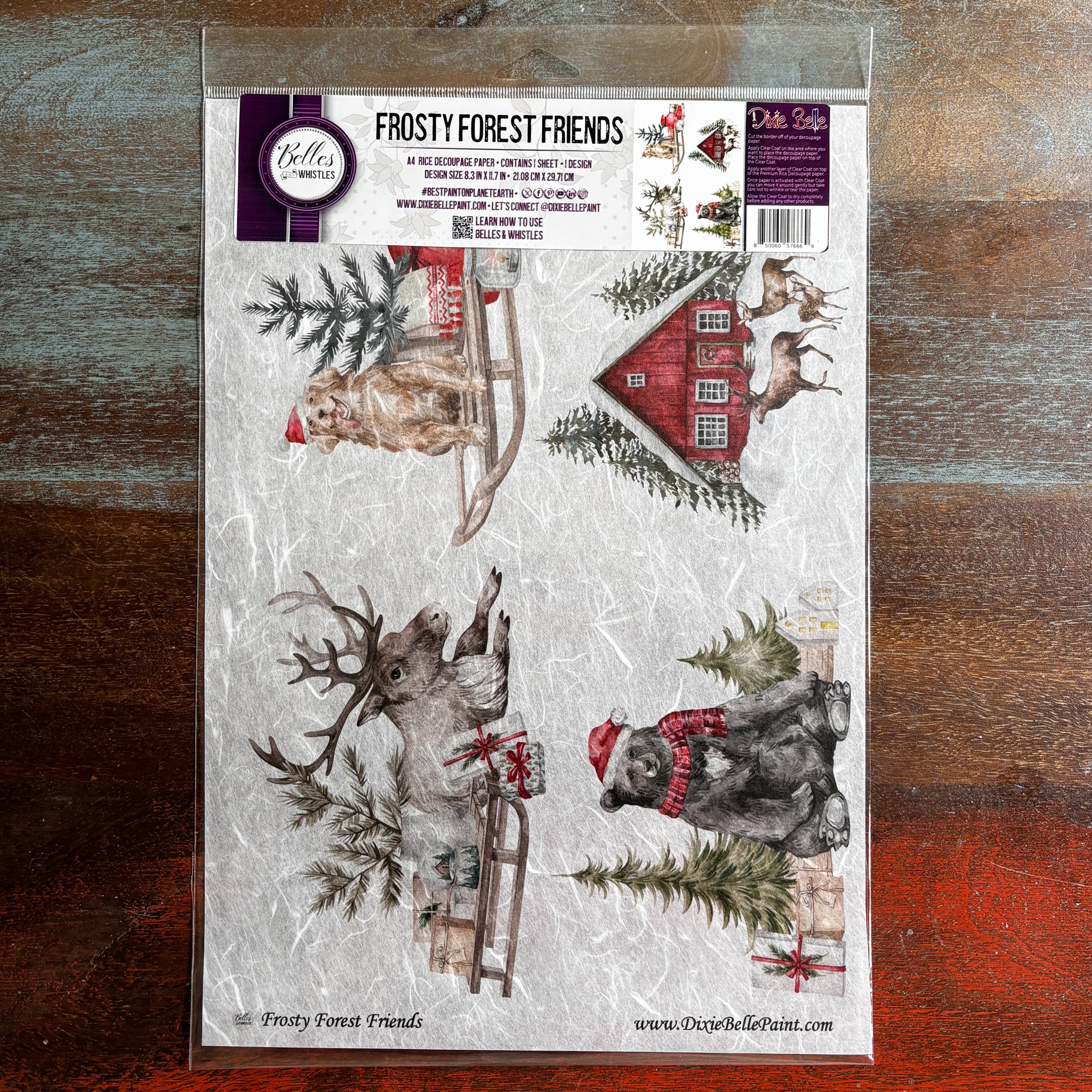 A package of Belles & Whistles' Frosty Forest Friends A4 rice paper is against a dark wood background.