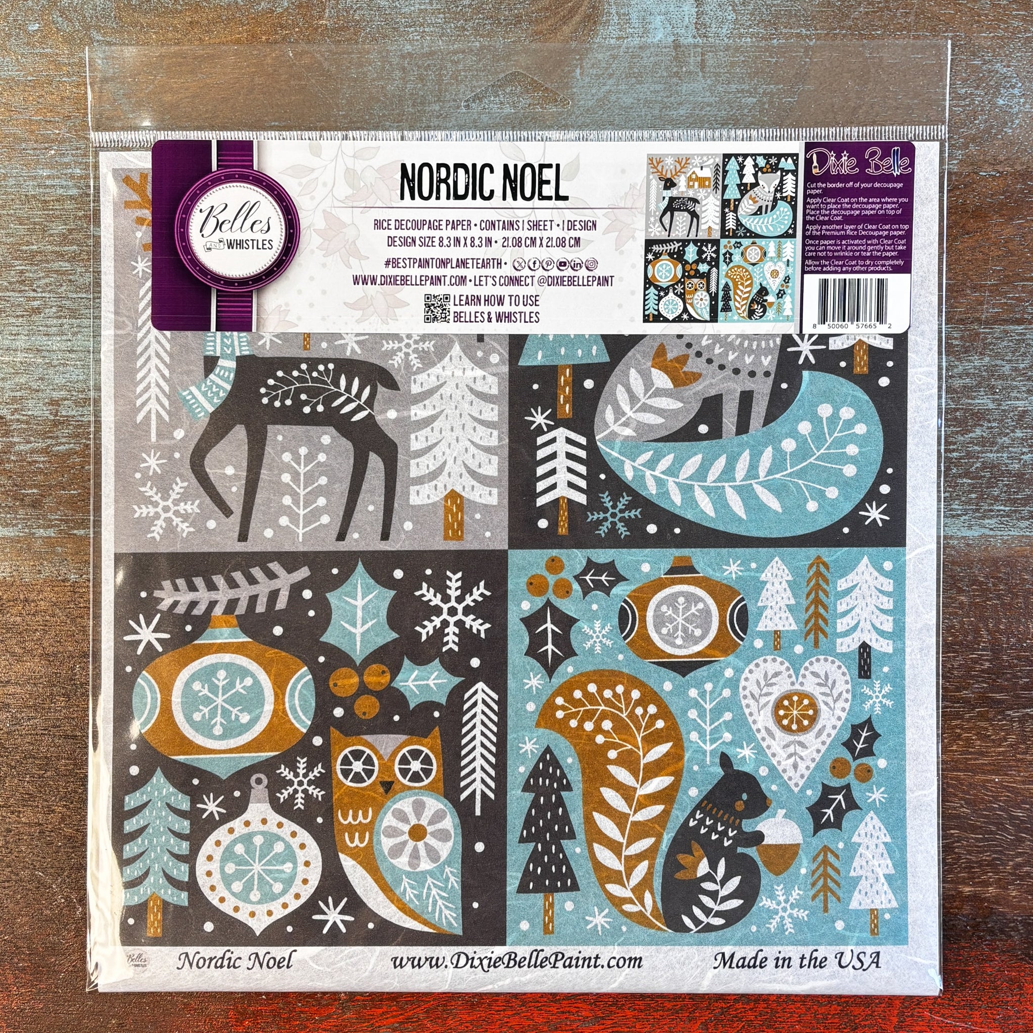 A package of Belles & Whistles' Nordic Noel rice paper is against a dark wood background.