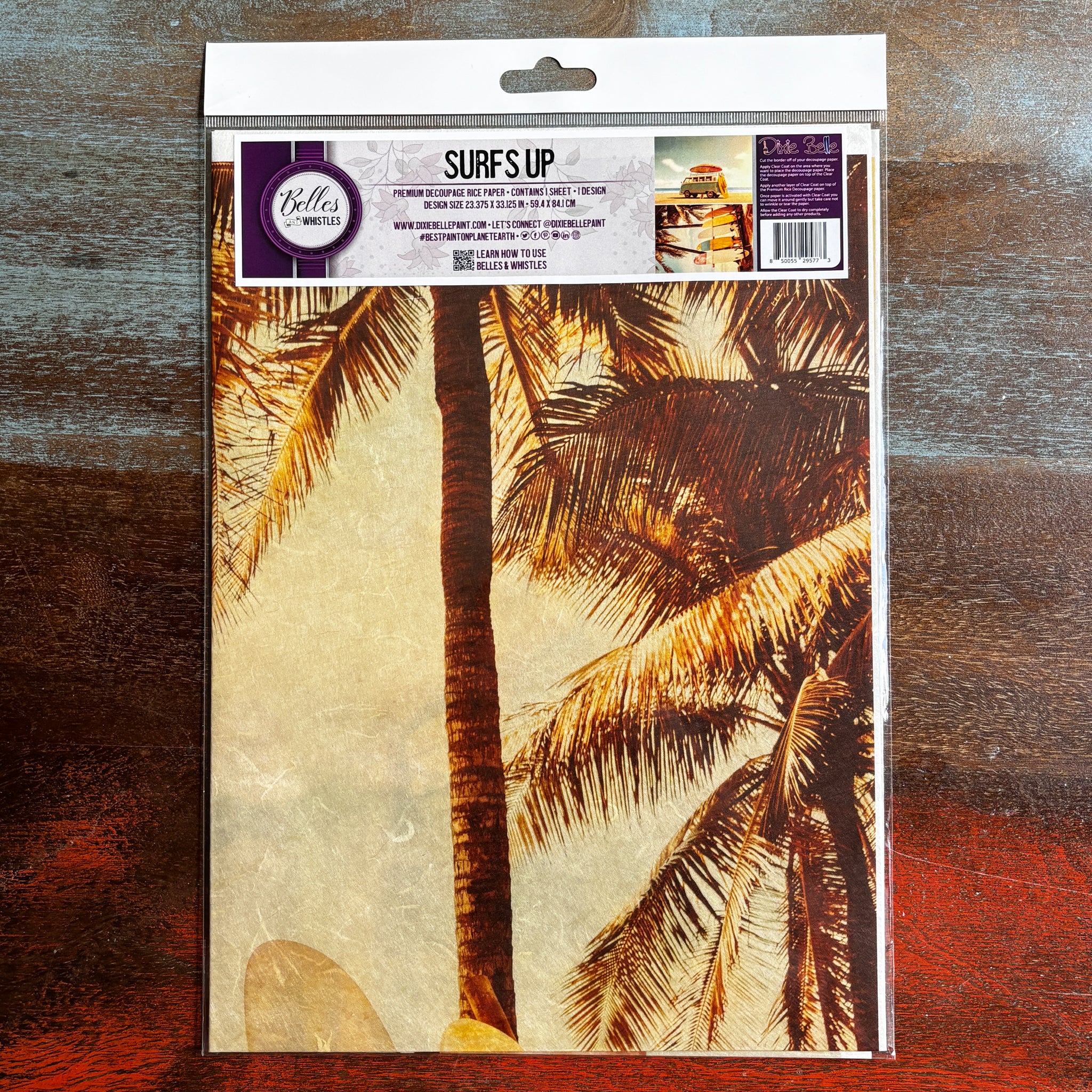 A package of Belles & Whistles' Surfs Up A1 rice paper is against a dark wood background.