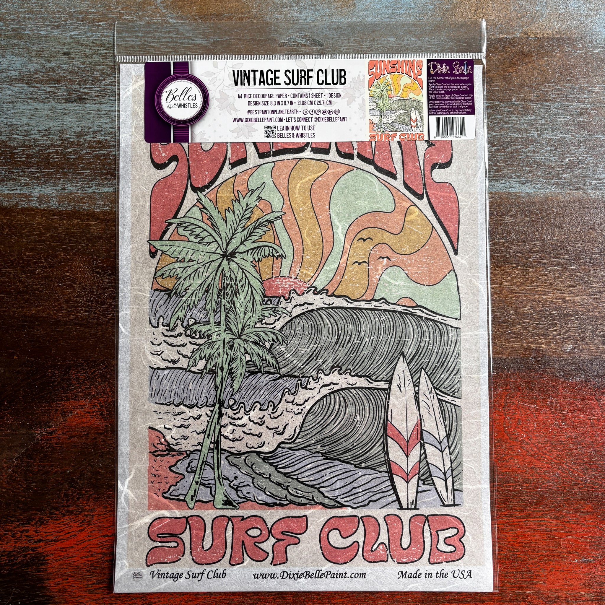 A package of Belles & Whistles' Vintage Surf Club A4 rice paper is against a dark wood background.