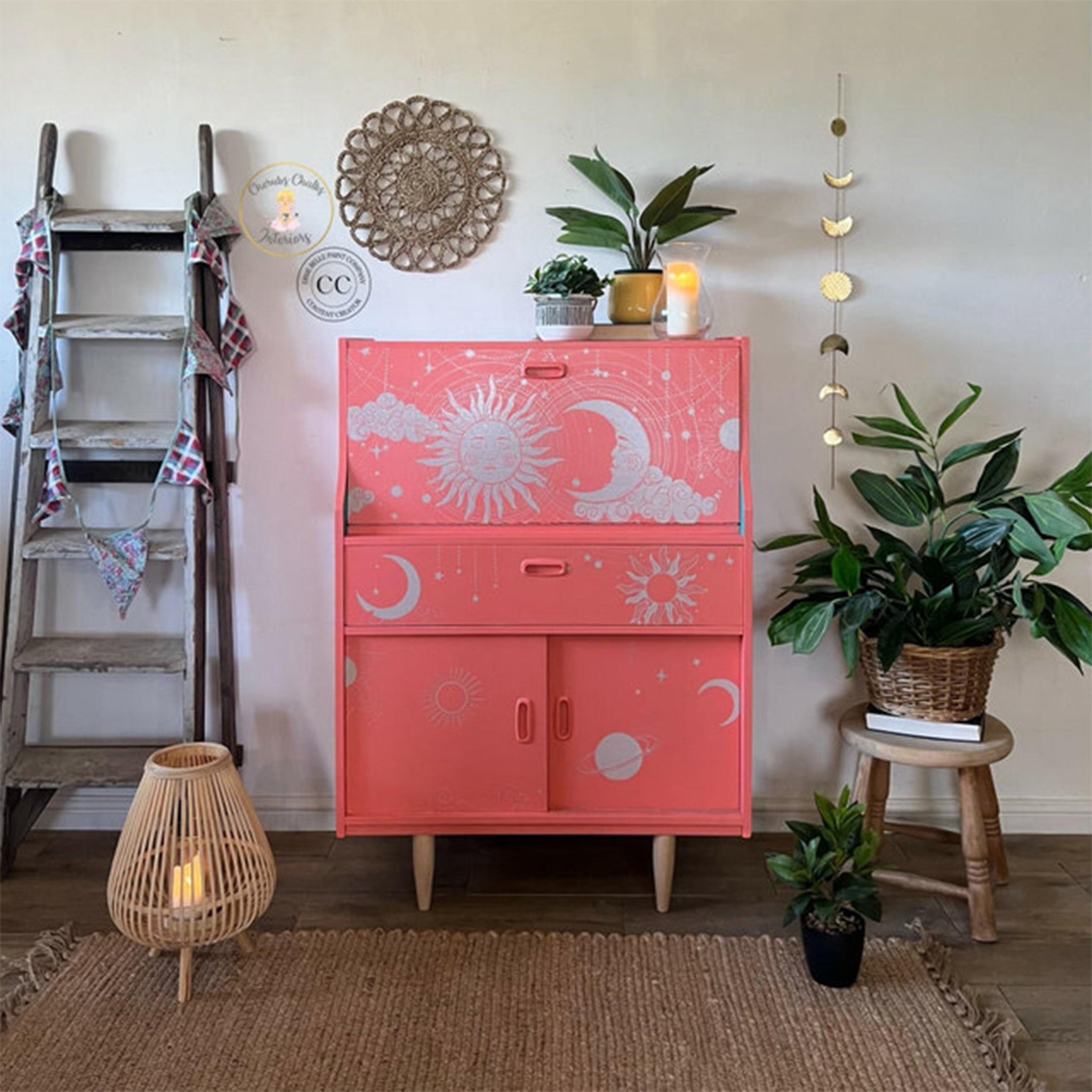 A vintage writing desk cabinet refurbished by Cherubs Chalks Interiors is painted bright salmon pink and features Belles & Whistles' Lani's Celestial Dream on it.