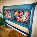 Decorative headboard with floral patterns on a wooden floor.