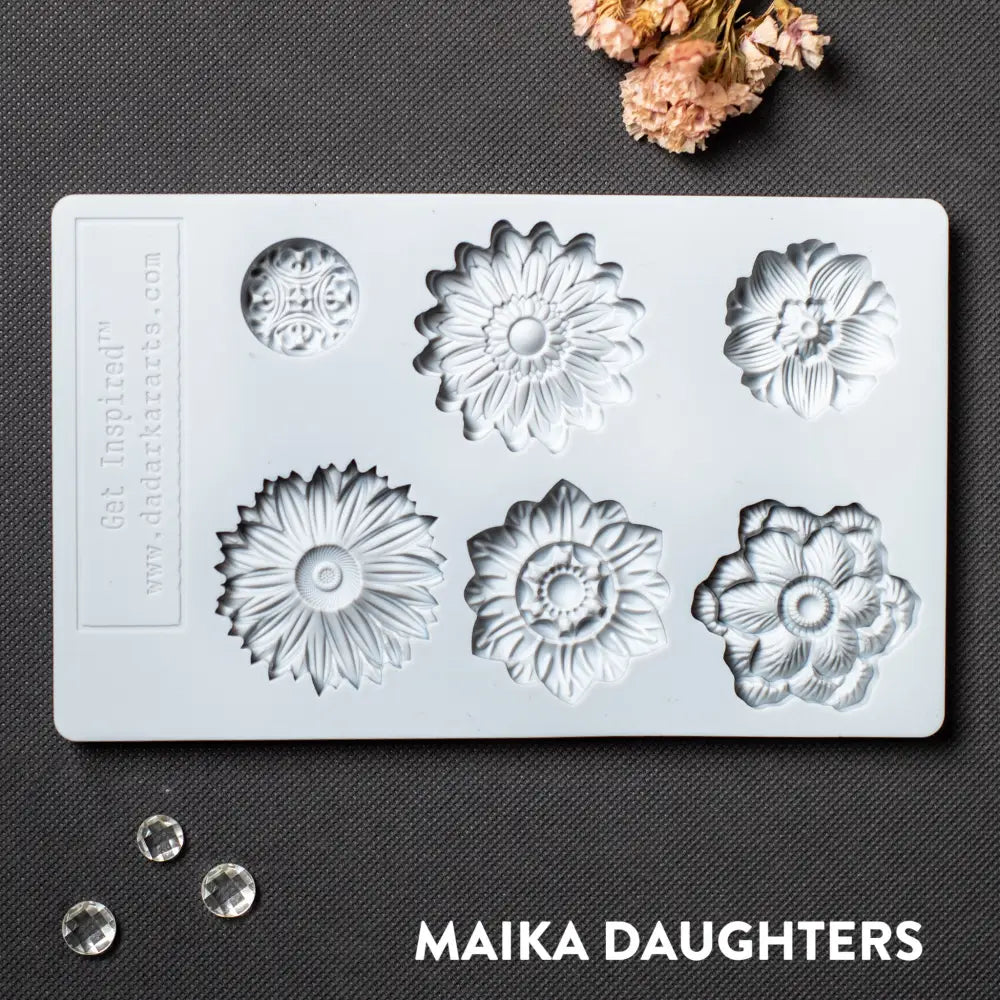 A light grey silicone mold featuring 6 posy flower heads is against a dark grey material background.