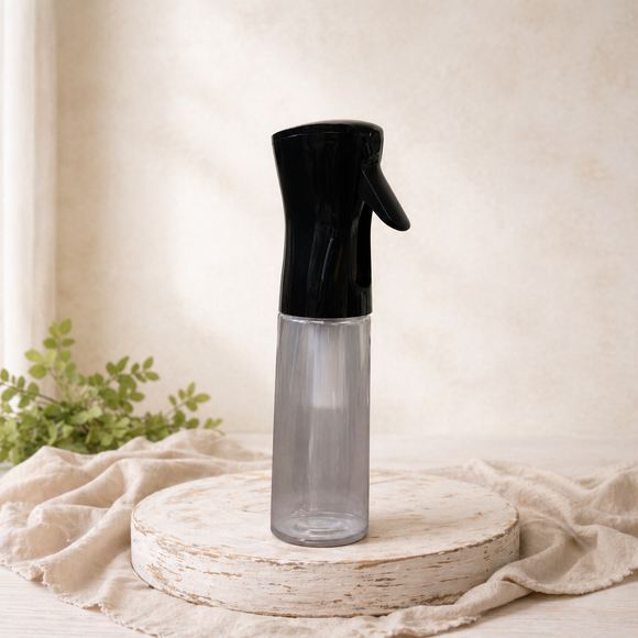 10 oz continuous fine mist spray bottle with black top and clear bottle displayed on a neutral studio pedestal.