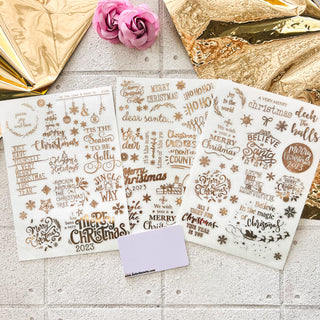 Three sheets of small rub-on transfers of gold foil Christmas greetings by Get Inspired by Dadarkar Arts.