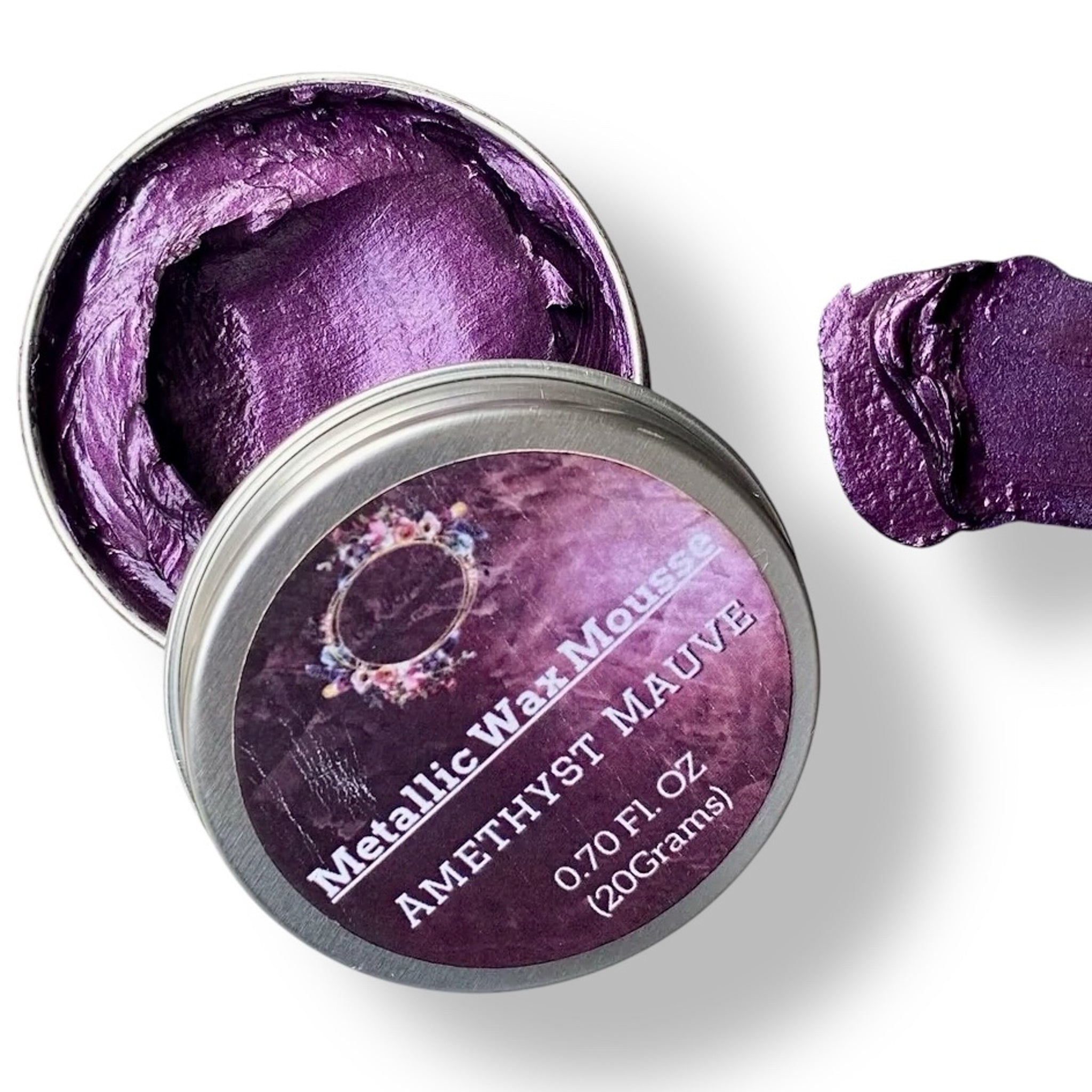 A 0.70 (20 ml) open container of a purple color metallic wax mousse paste is against a white background.