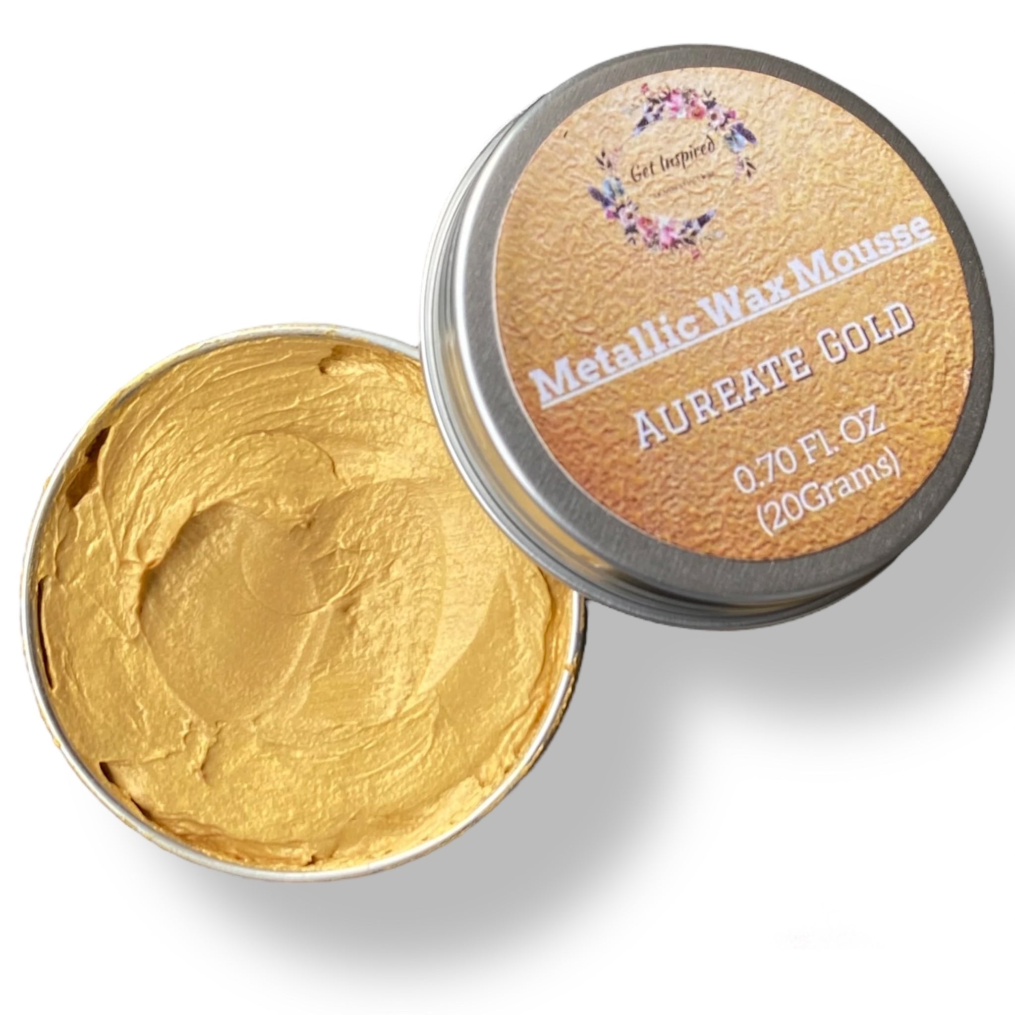 A 0.70 (20 ml) open container of a gold color metallic wax mousse paste is against a white background.