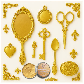 An open container of Dadarkar Art's Aureate Gold Metallic Wax Mousse is amongst resin silicone mold castings of vintage items including a hand mirror, scissors, a spoon, a key, and various corner and accent flourishes.
