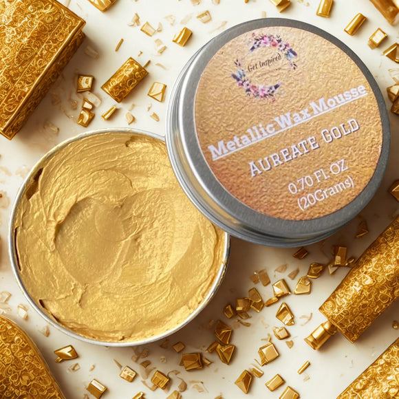 A 0.70 (20 ml) open container of a gold color metallic wax mousse paste is shown with chunky gold crafting crystals.