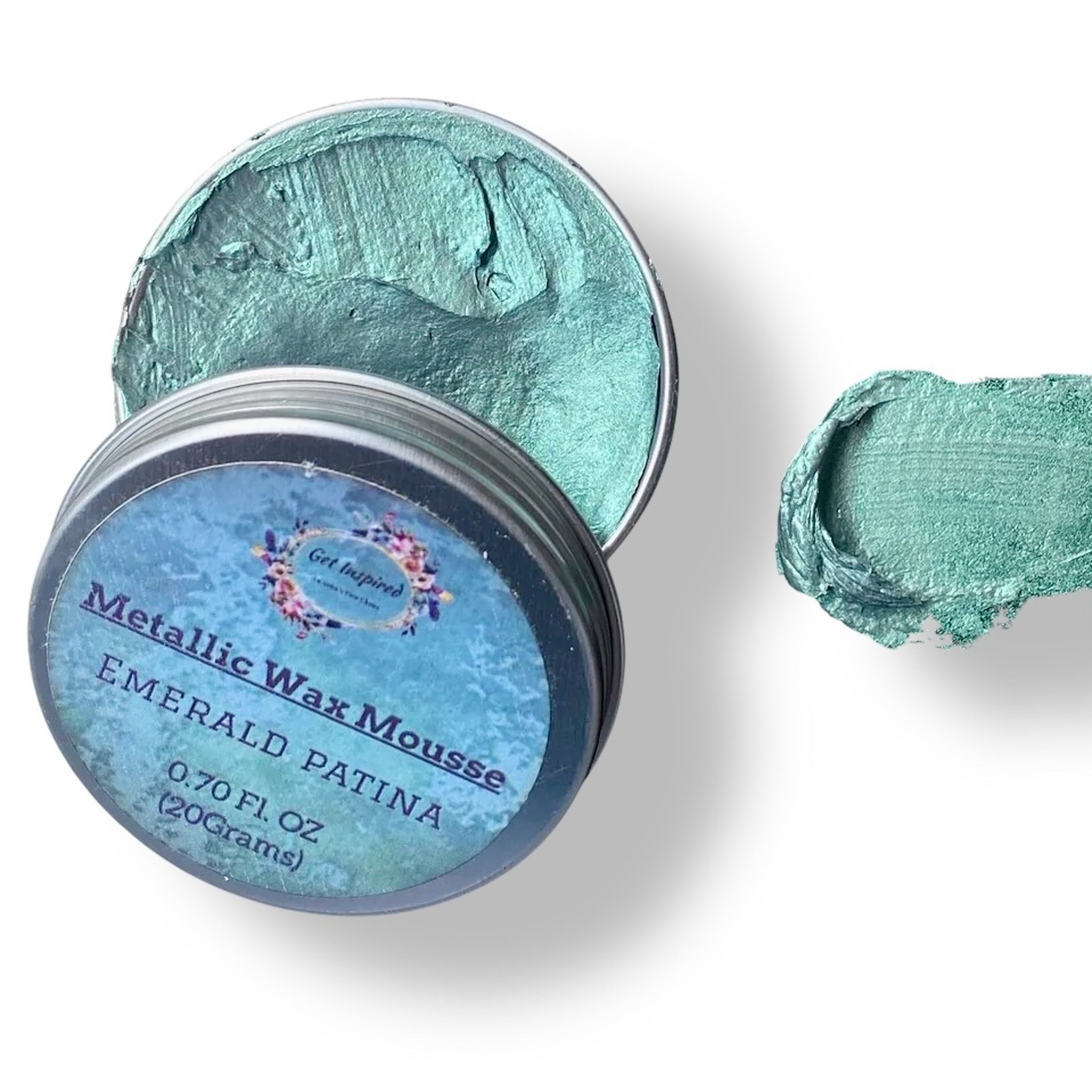 A 0.70 (20 ml) open container of a green patina color metallic wax mousse paste is against a white background.