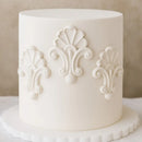 White cake with decorative patterns on a neutral background
