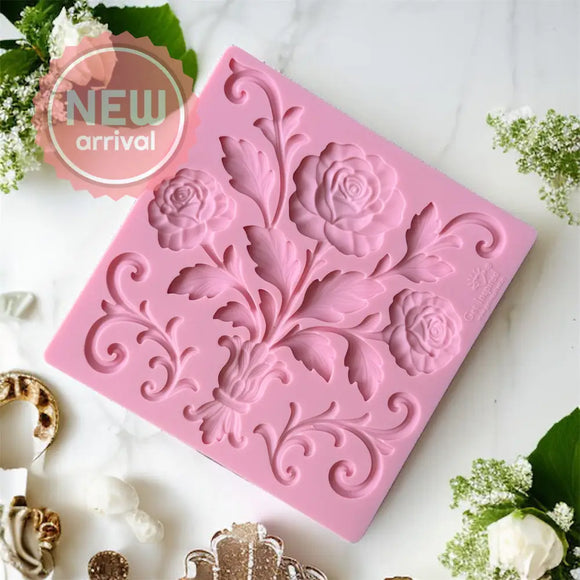 Pink floral silicone mold on a white surface with decorative elements.