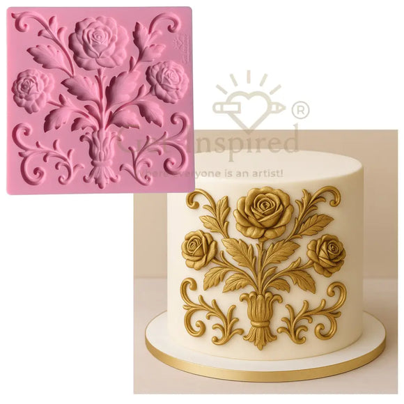 Pink silicone mold with floral design next to a cake decorated with gold floral patterns
