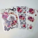 Three sheets of small rub-on transfers featuring designs of delicate French script adorned with butterflies, small bouquets of roses, and a delicate damask pattern are against a white background.