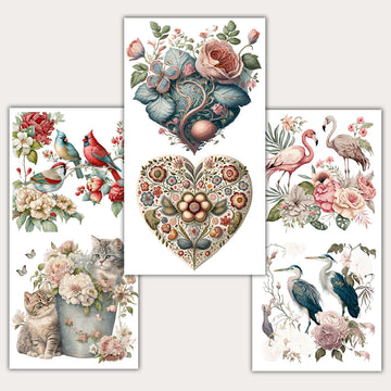 Three sheets of small rub-on transfers featuring exotic birds, floral hearts, and even kittens in a metal bucket surrounded by flowers in dreamy pinks, blues, and reds are against a light beige background.