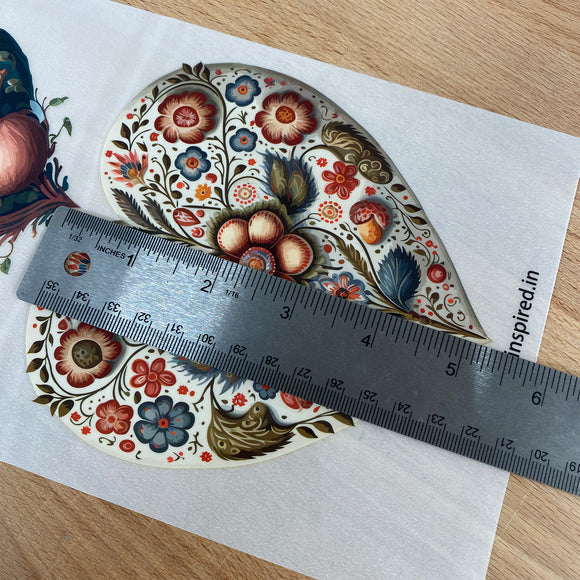 Decorative heart transfer with floral patterns on a white surface, measured by a ruler.