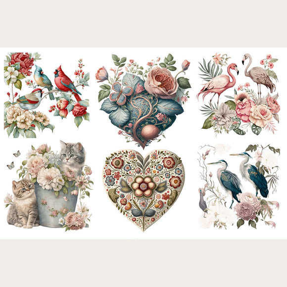 Small rub-on transfers featuring exotic birds, floral hearts, and even kittens in a metal bucket surrounded by flowers in dreamy pinks, blues, and reds are against a white background. Light beige borders are on the top and bottom.