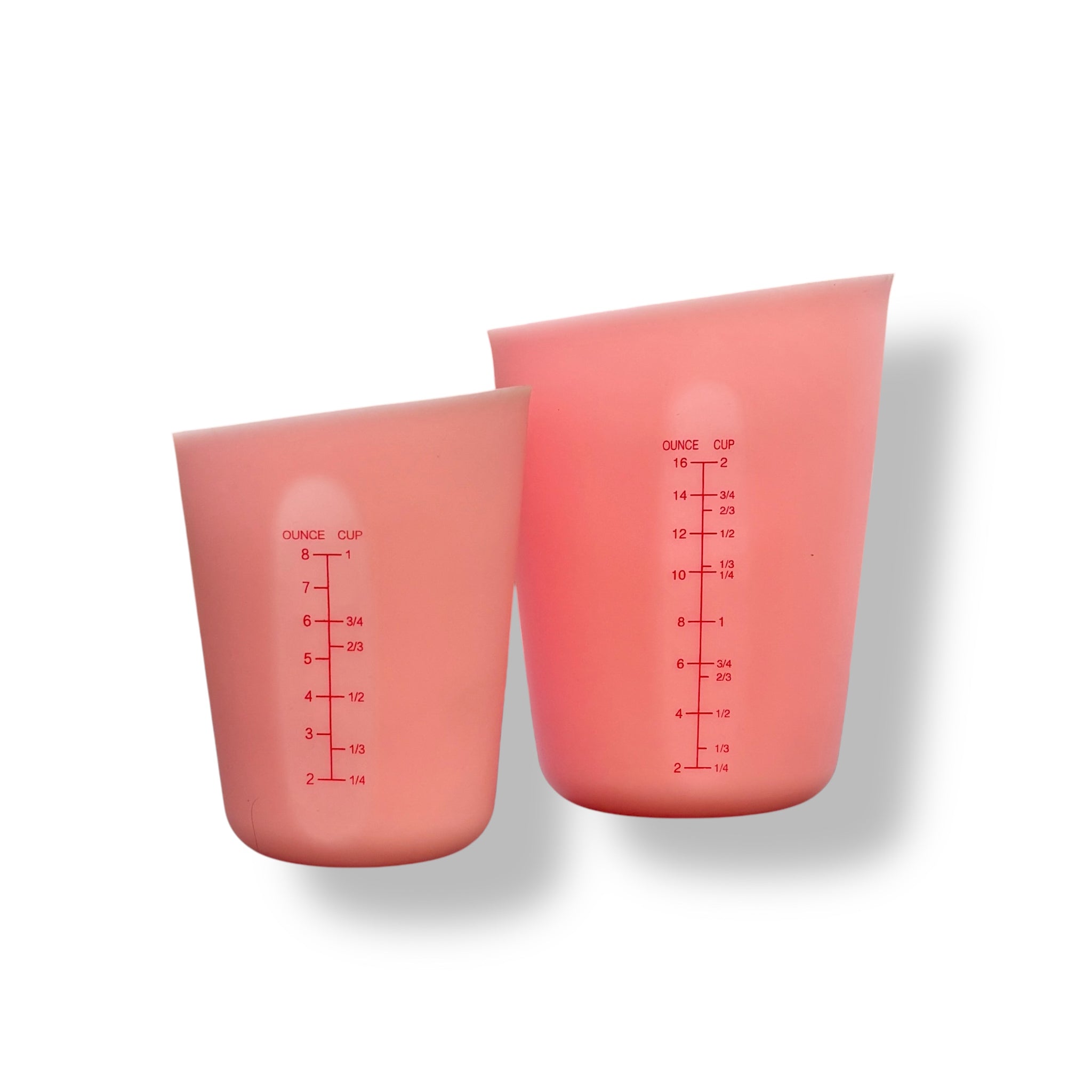 Two light pink silicone measuring cups in 8oz and 16oz are against a white background.