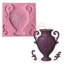 Pink silicone mold of a decorative vase next to a purple cast of the vase on a white background