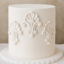 White cake with decorative patterns on a neutral background