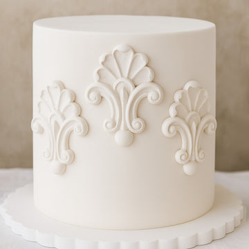 White cake with decorative patterns on a neutral background